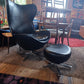 Egg-Style Swivel Chair and Footstool in Black Leather — photograph 4