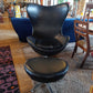 Egg-Style Swivel Chair and Footstool in Black Leather — photograph 2