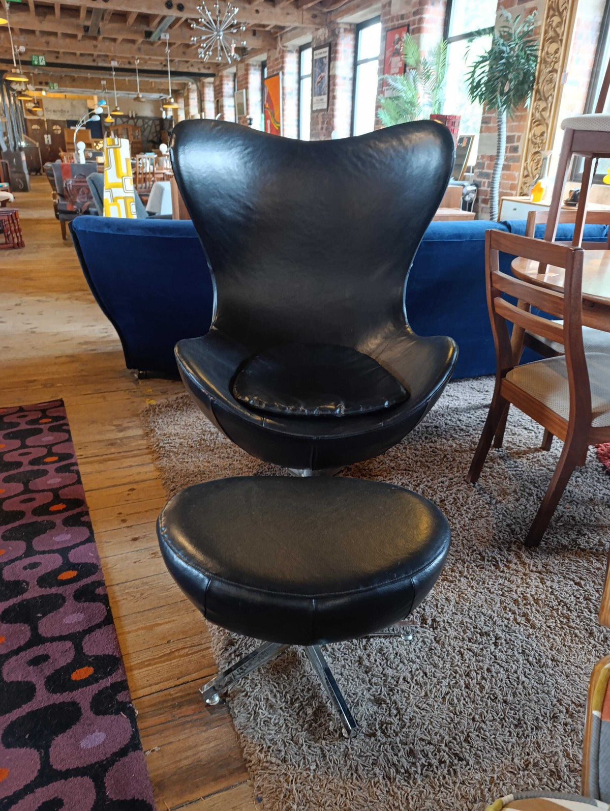 Egg-Style Swivel Chair and Footstool in Black Leather — photograph 2