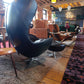 Egg-Style Swivel Chair and Footstool in Black Leather — photograph 5