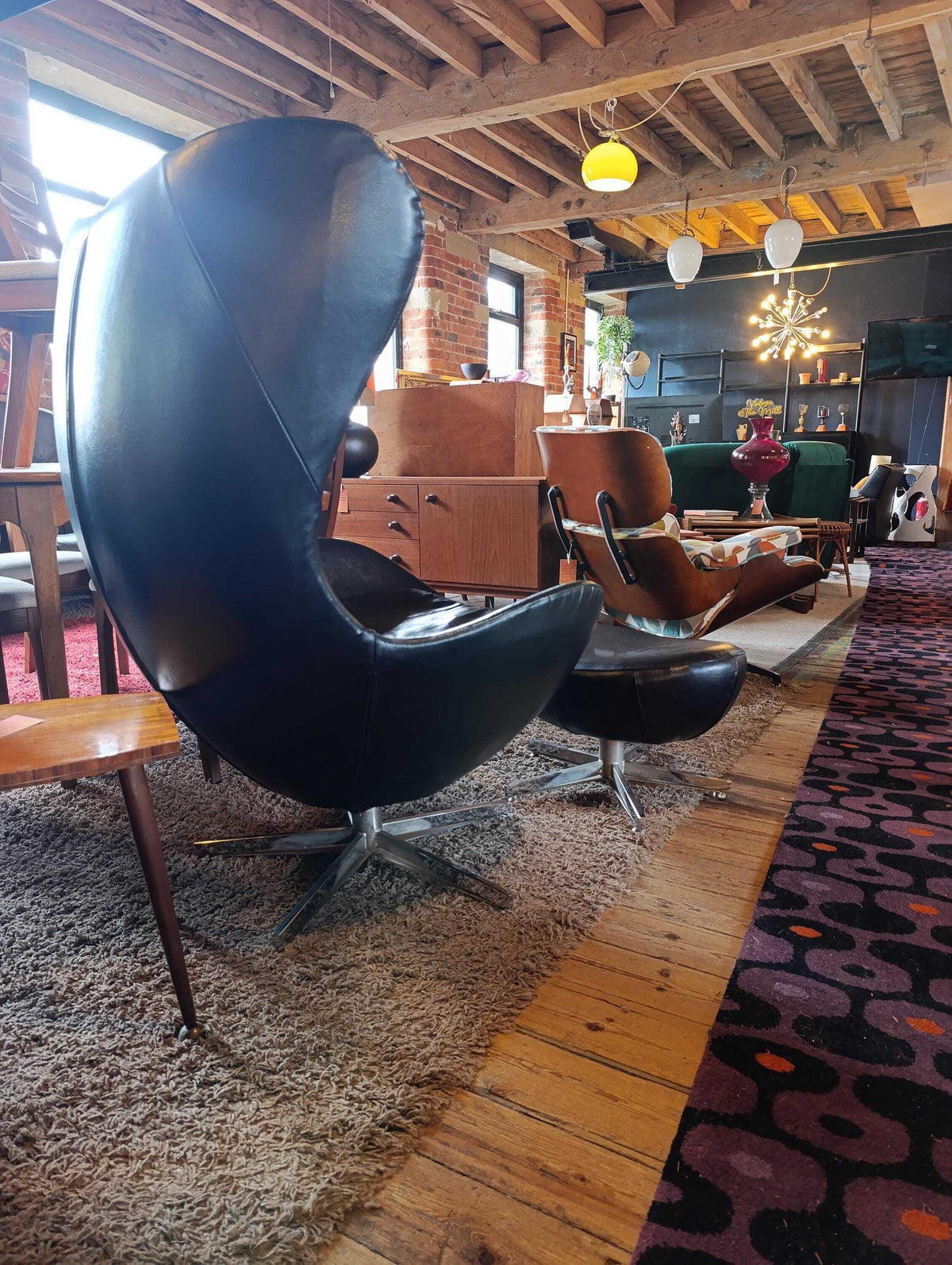 Egg-Style Swivel Chair and Footstool in Black Leather — photograph 5